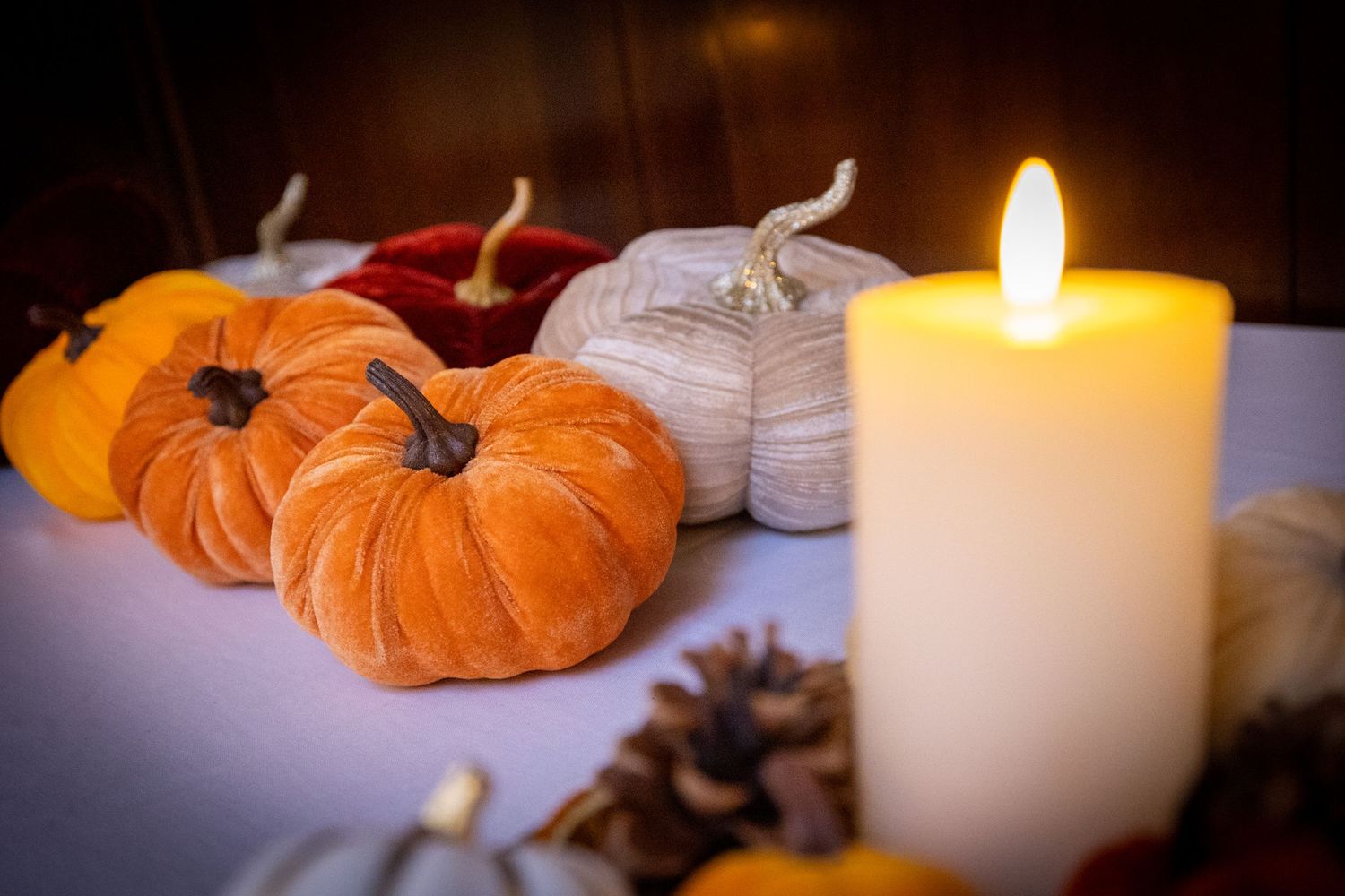 soft plush pumpkins and candles wedding decor at the Athenaeum Liverpool City Centre. Stuart Morris Liverpool wedding photography