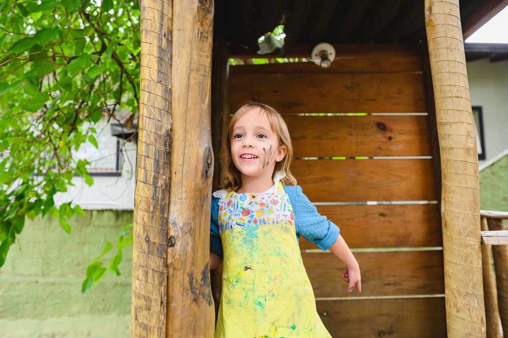 Children enjoy outdoor learning activities in a colorful garden setting during summer camp.