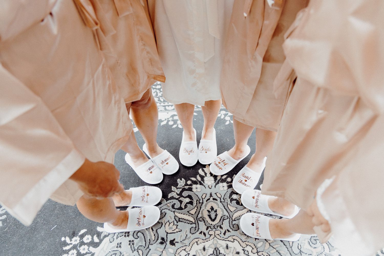 Aerial view of white bridal shoes arranged in a circular pattern captured by Apertured Media Auckland Wedding Photographer.