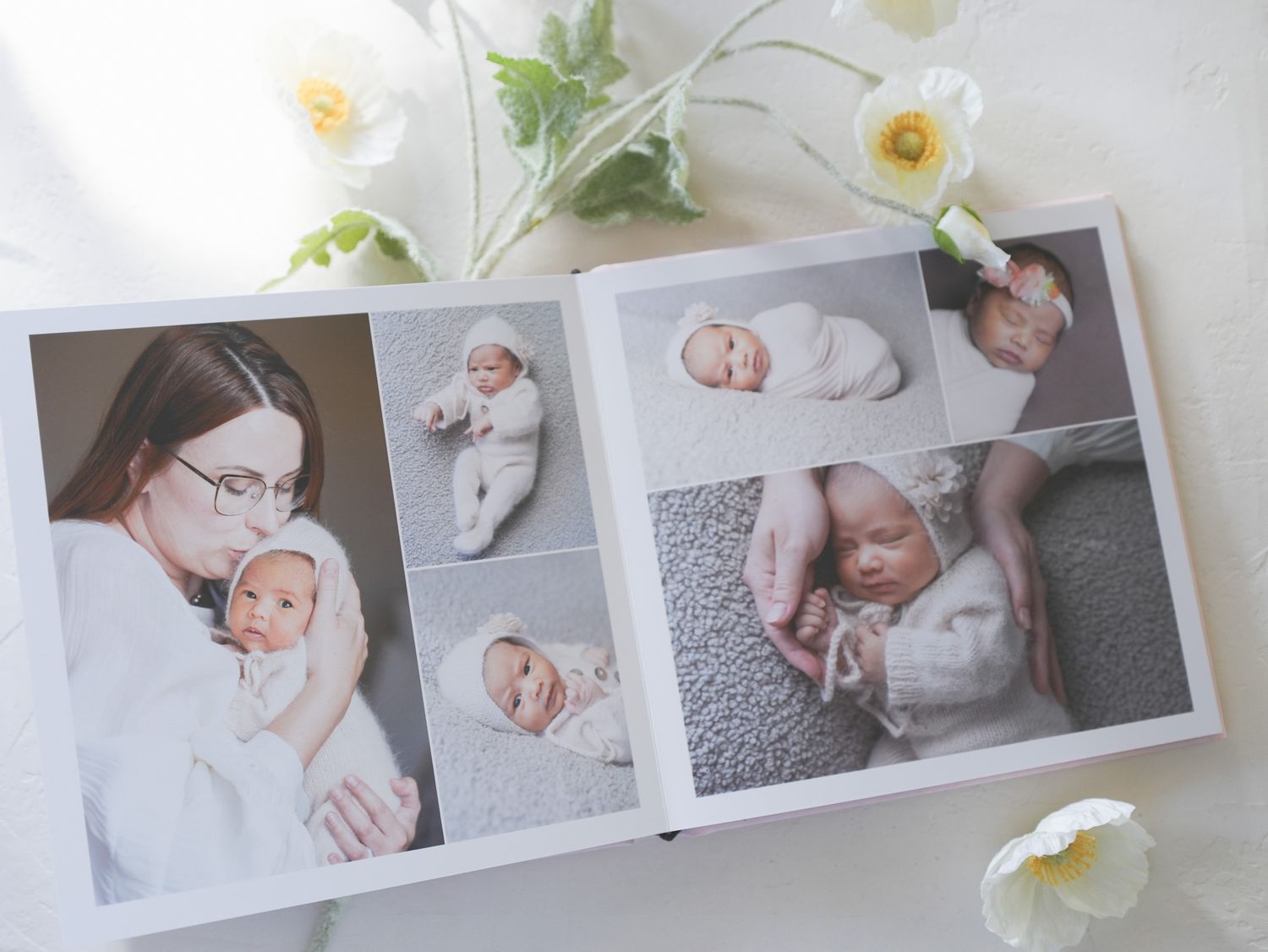 Professional photo album spread showing family portraits and baby pictures in soft tones.