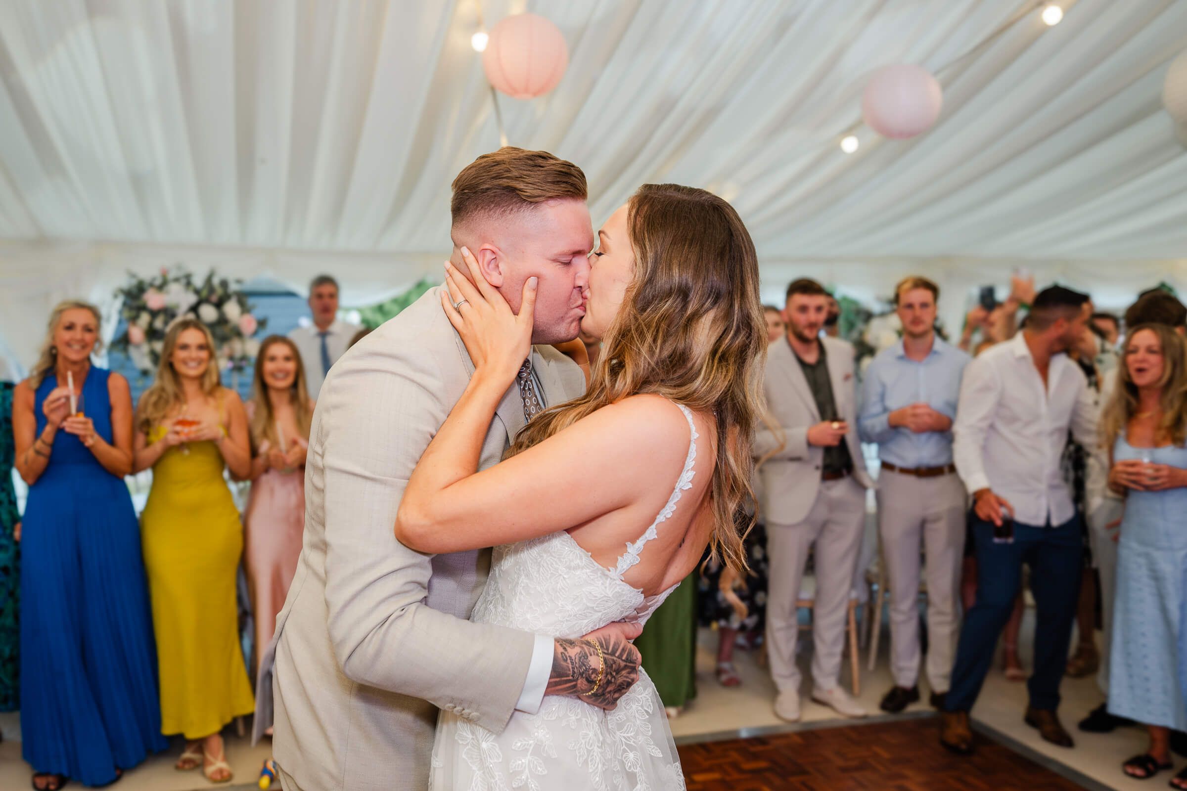 bride and groom kiss at a home wedding in garden