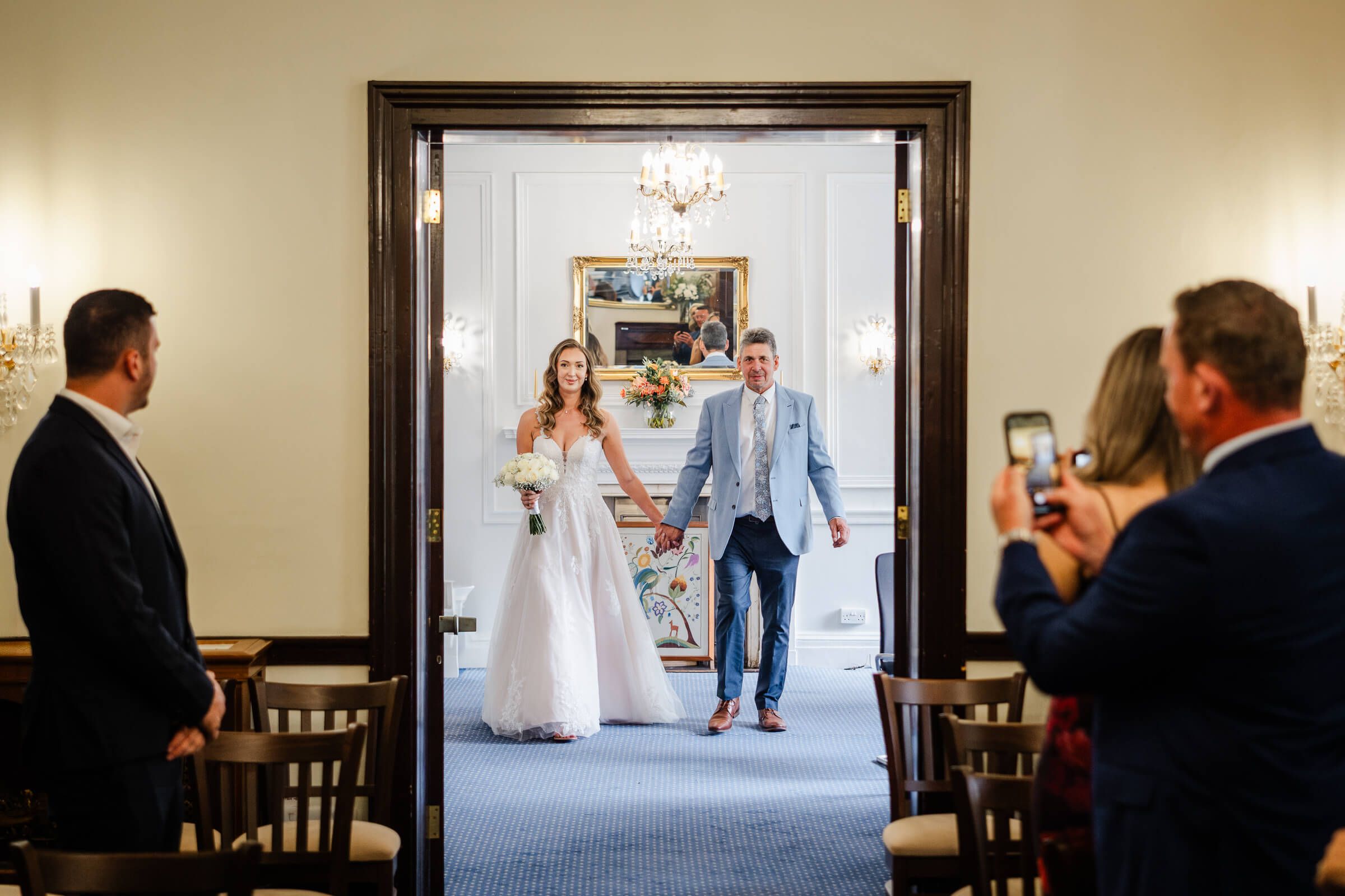 Bride with father of the bride walking up aisle