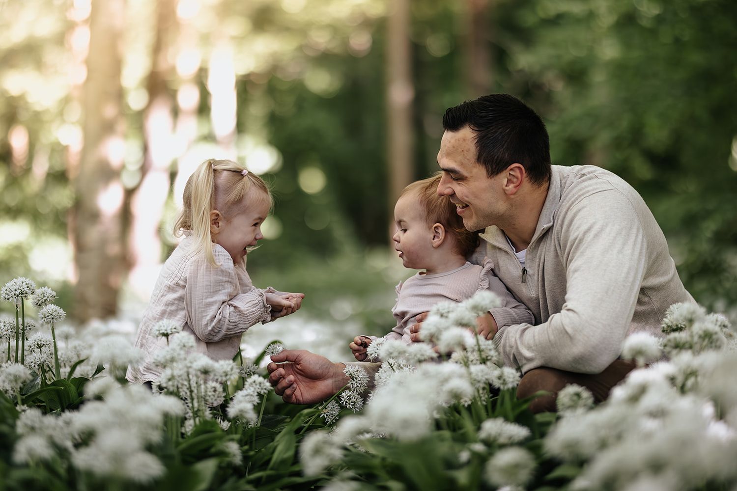 Someone tenderly interacting with snail on grass in a springtime outdoor setting.