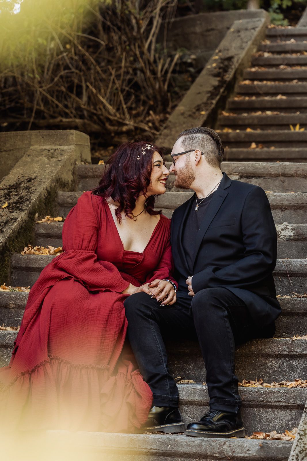 A romantic moment shared on stone steps during an outdoor wedding photoshoot.
