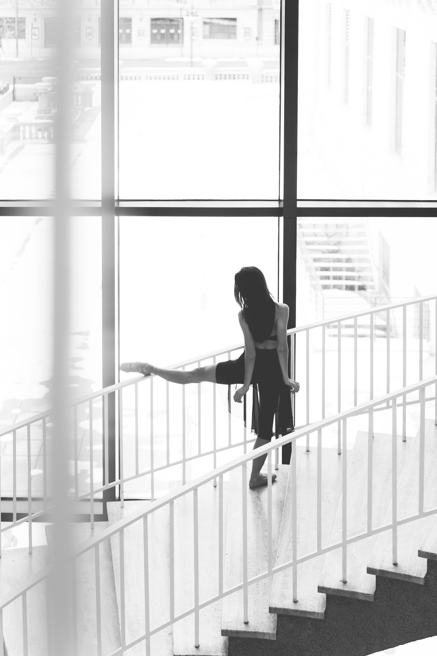 black and white image Ballet dancer captured in elegant pose with the Art Institute of Chicago architecture in the background. Dance Photo