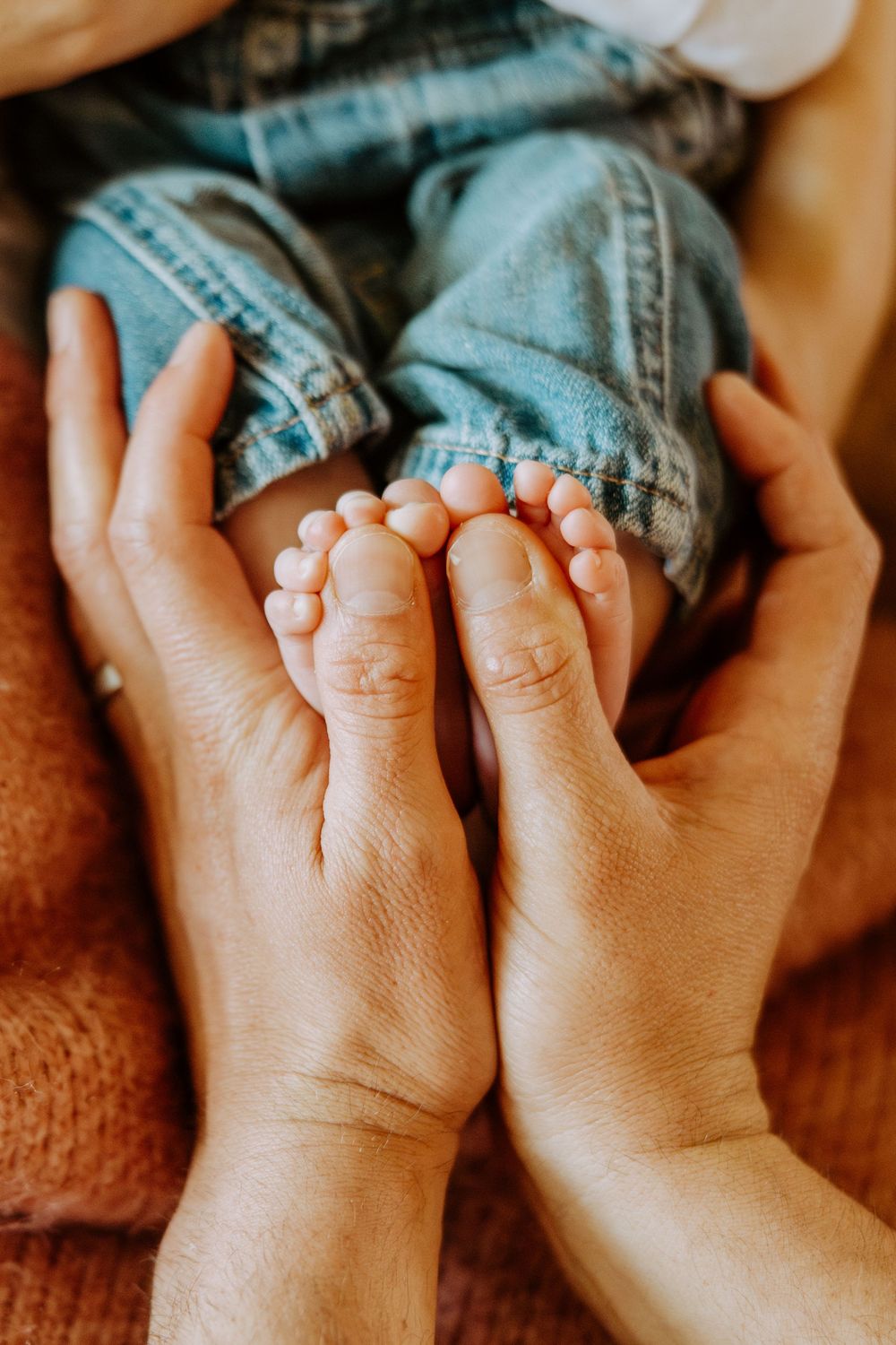 Close-up shot of tiny baby toes on denim jeans creating a heartwarming progression of images.
