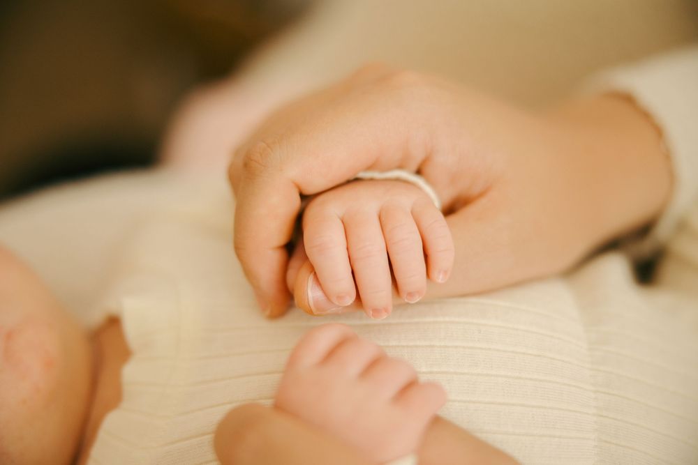 A series of close-up photos showing hands gently resting on the pages of an open book.