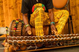 Traditional African drums and percussion instruments lined up during a performance.