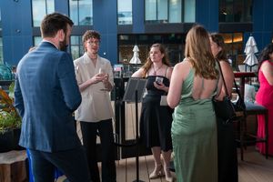 Guests mingle and socialize at an elegant reception with modern decor.