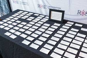 Name cards arranged on black tablecloth at event registration or check-in table.