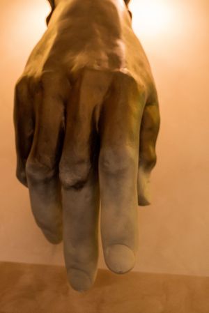 Close up view of a rubber glove with dramatic lighting creating shadows and depth.