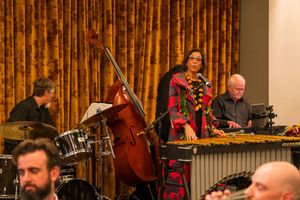Musicians performing with upright bass and xylophone during formal dinner event.