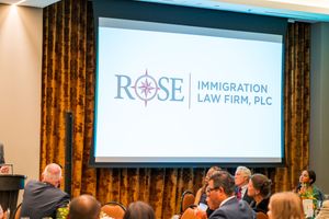 Professional presentation showing Rose Immigration Law Firm logo on projection screen.