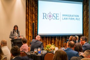 Professional presentation setup with law firm logo displayed on screen in conference room.