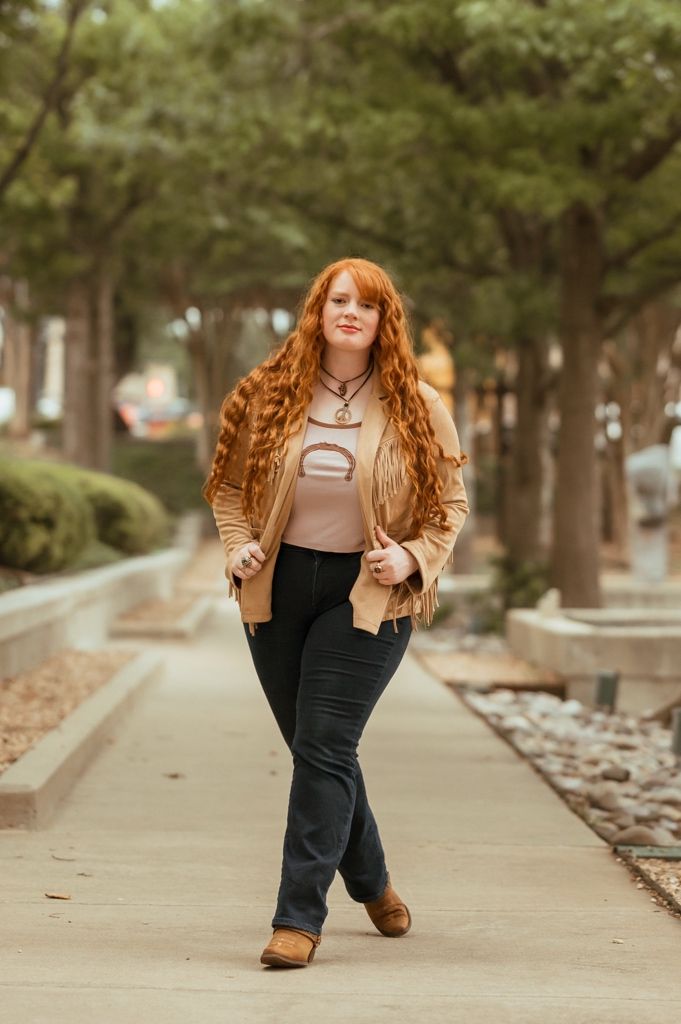 A series of playful poses captured on a tree-lined autumn path, wearing a brown jacket and dark pants.