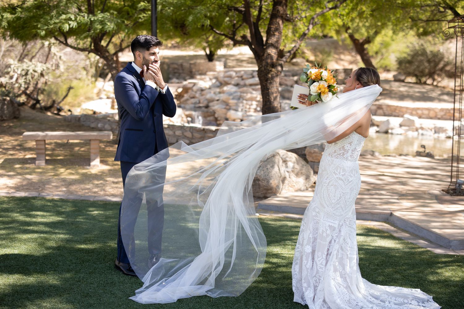 Flowing white wedding veil caught in breeze during outdoor photoshoot.