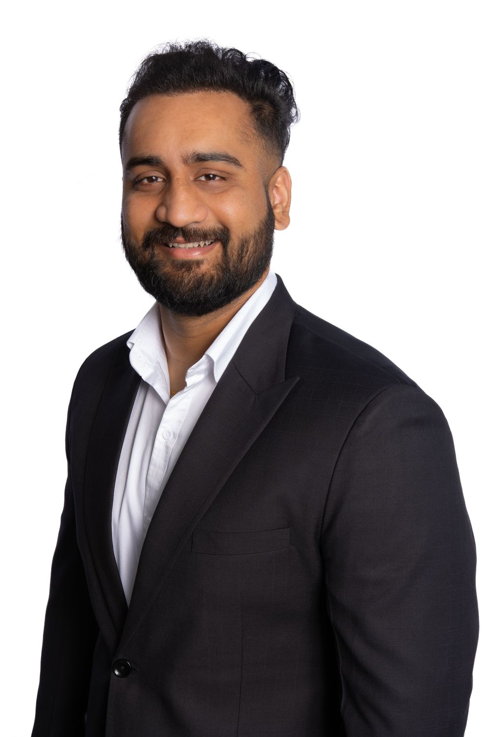 Professional business headshots of a man with a beard wearing a black suit and white shirt smiling at the camera.