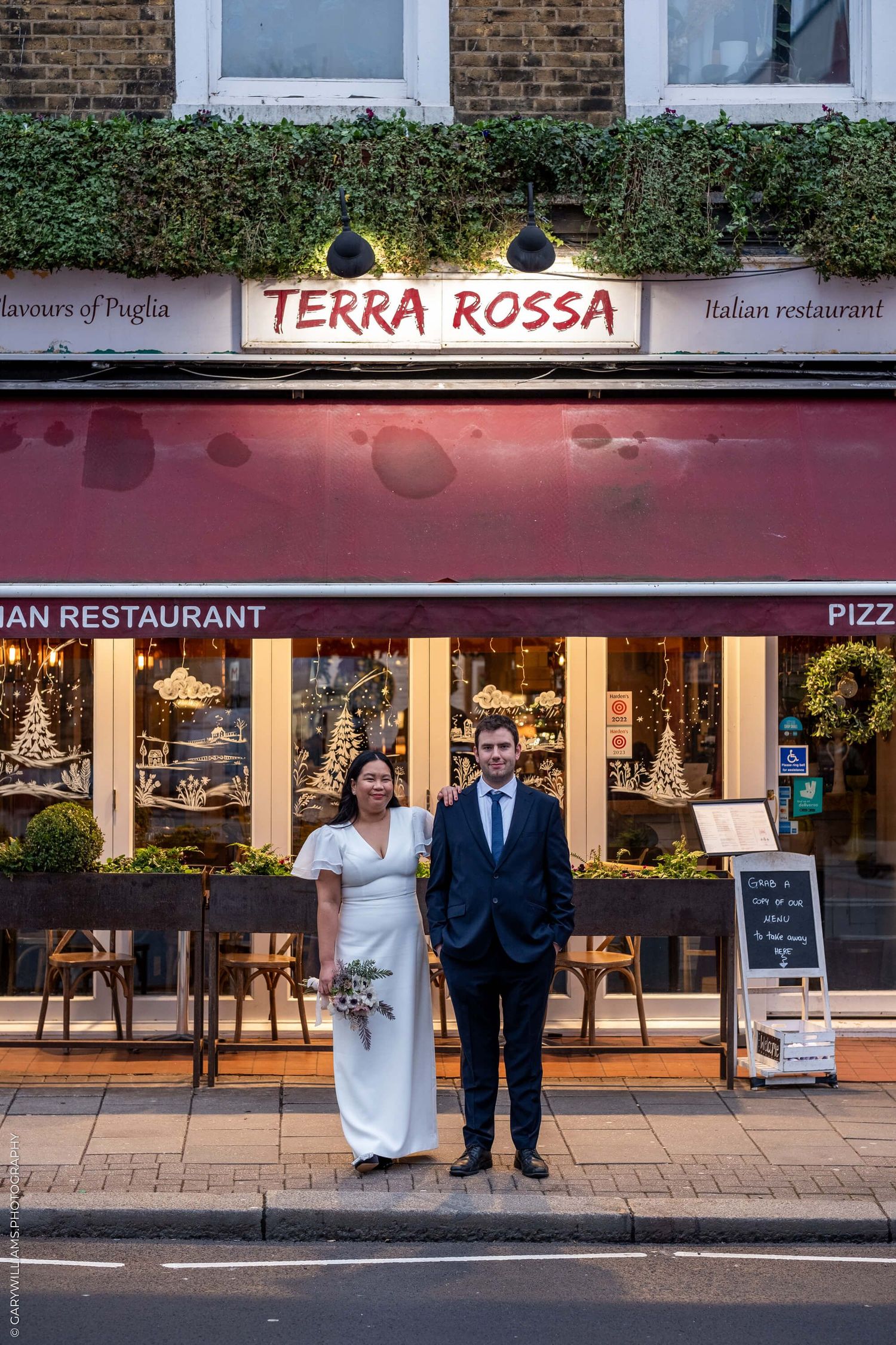 Exterior view of Terra Rossa Italian restaurant with classic storefront and illuminated signage in London.