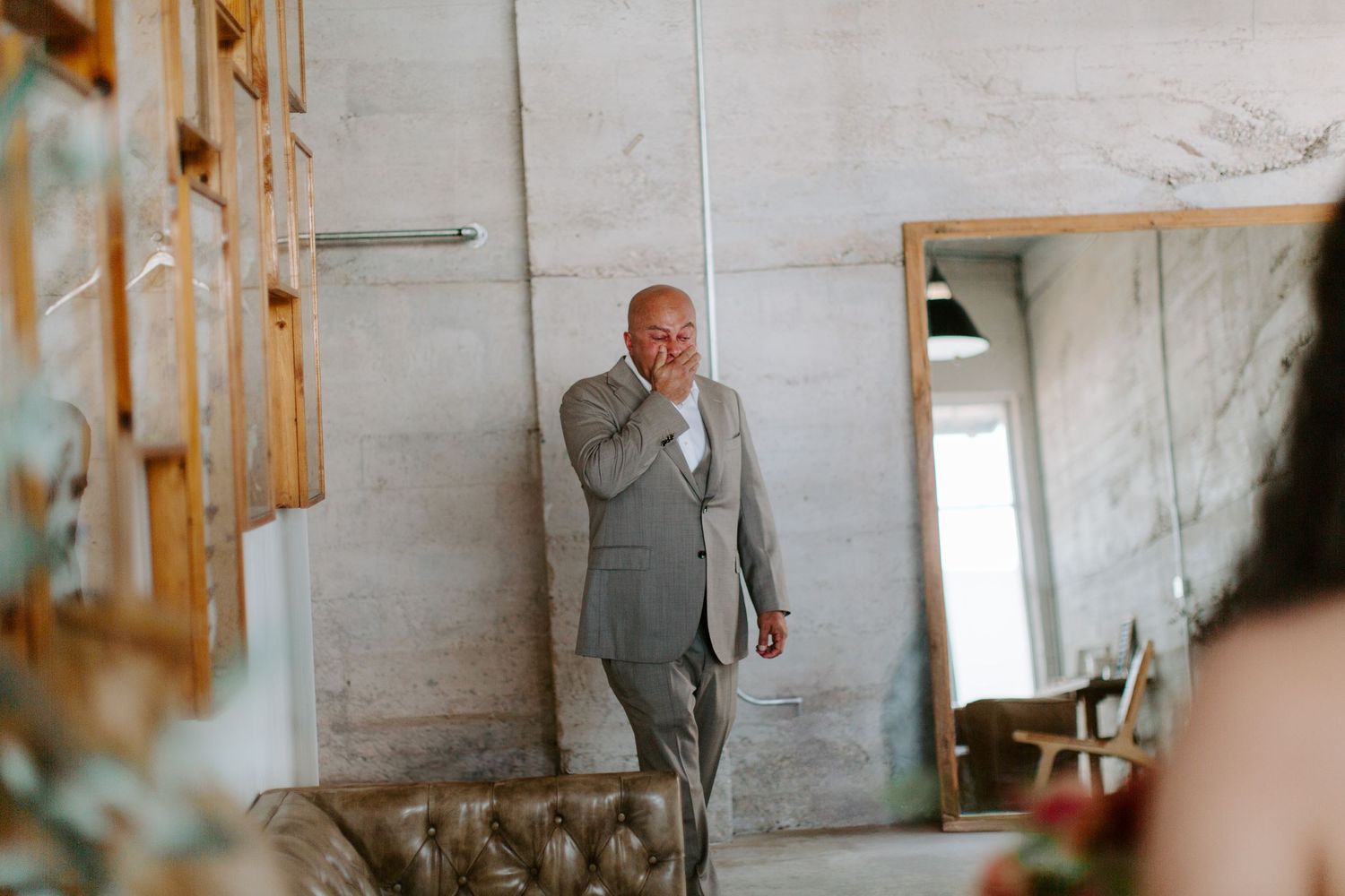 Emotional first look moment in a modern industrial wedding venue.