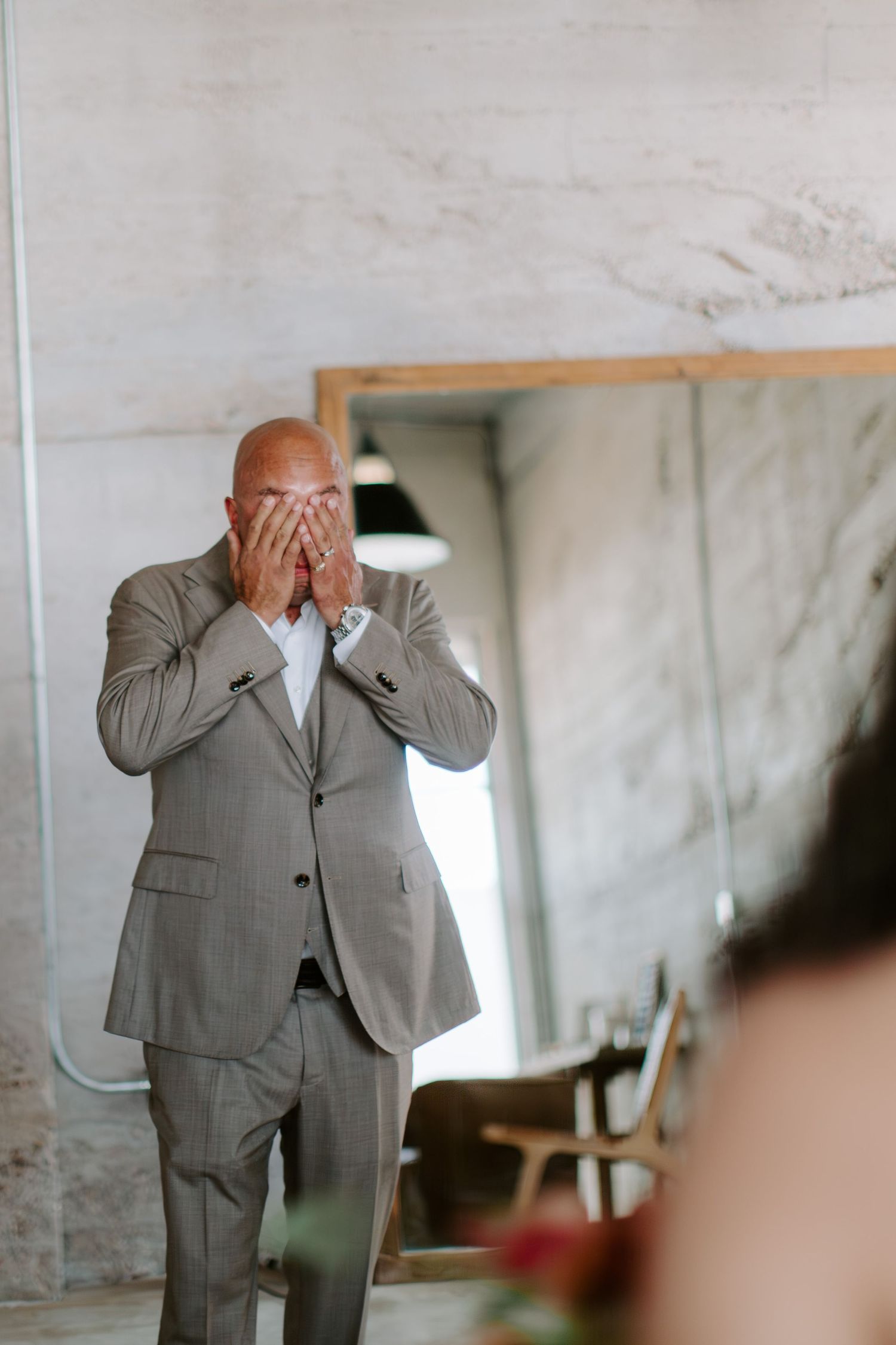 Candid reaction shot showing pure emotion during a wedding moment.
