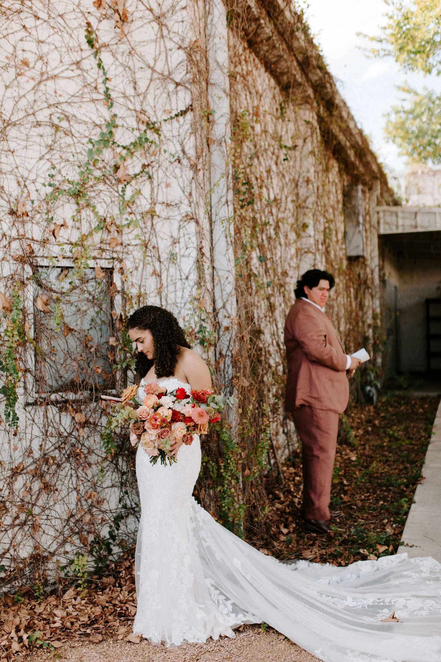 A beautiful wedding scene with ivy-covered walls and a flowing white dress train.
