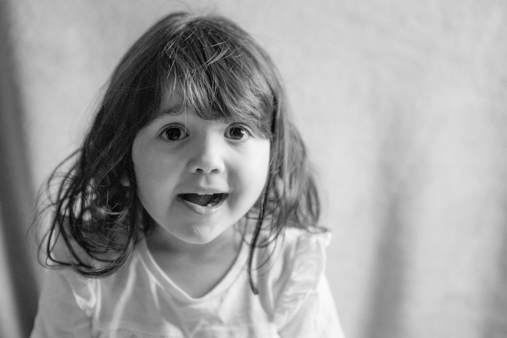 A series of black and white emotional expressions showing joy and laughter in different poses.