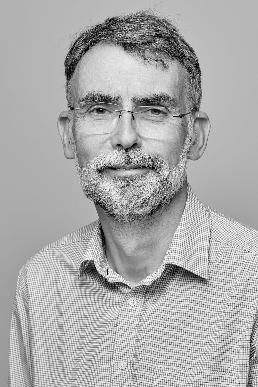 Sequence of close-up portraits showing person with grey hair and distinctive handlebar mustache smiling.