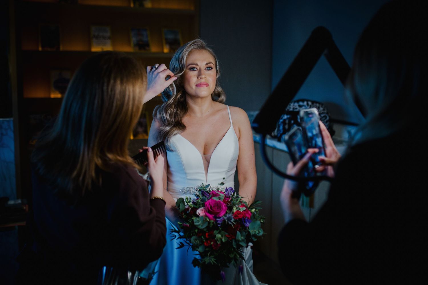 A wedding celebration inside a rustic barn venue with flowers and string lights creating a romantic ambiance.