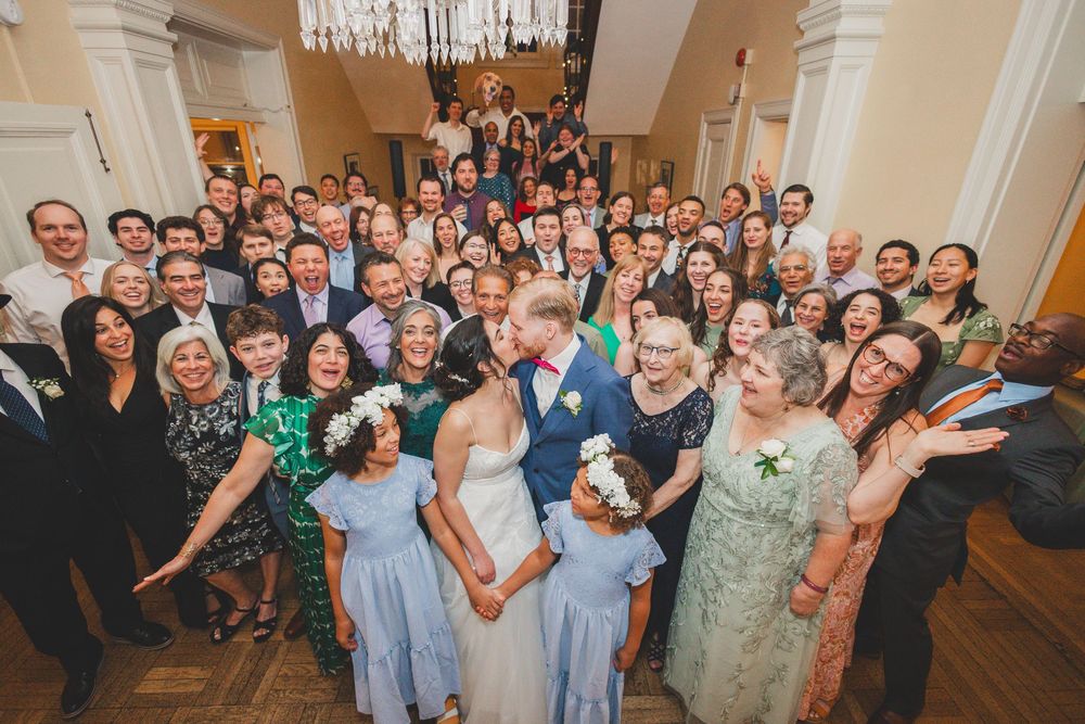 A large group wearing formal attire gathers on a grand staircase for a celebratory event photo at the Josephine Butler Parks Center