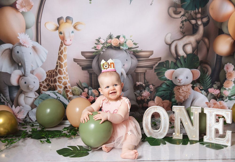First birthday celebration setup at a with soft plush animals, balloons, and 'ONE' letters in a dreamy nursery theme decor in Bexley London