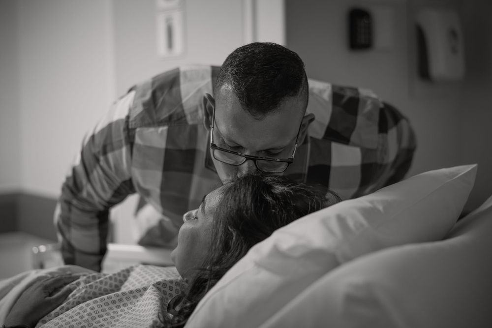 mom and dad share an emotional moment before c-section Birth Photography cape town By Grace Photography