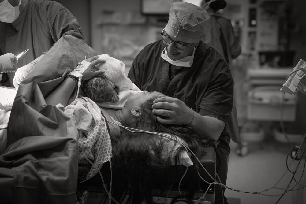 New little family in theatre c-section birth photographer Cape Town By Grace Photography
