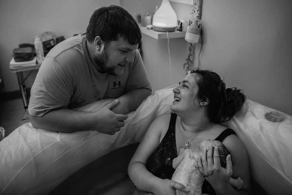 mom and dad sharing a moment cape town birth photographer By Grace Photography