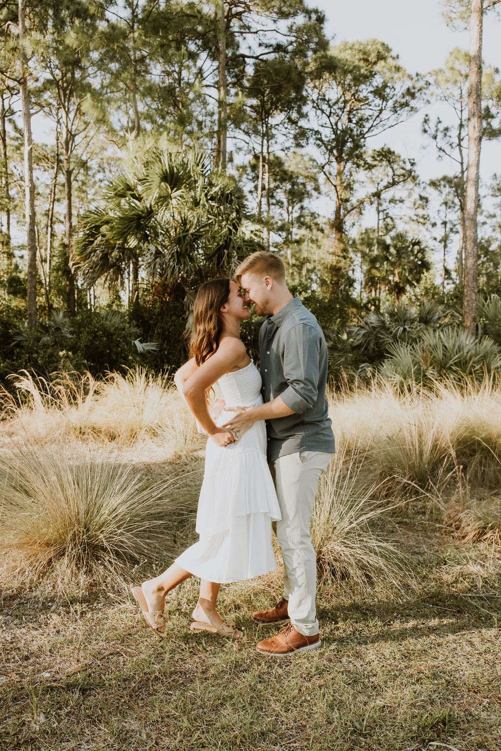 Golden hour Engagement photos captured by Lindsay McDow Photography in the greenery of a nature trail in West Palm Beach, Florida