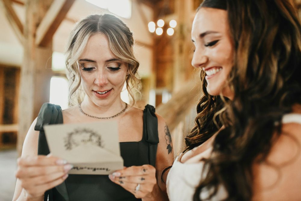 the bride gives her matron of honor a thank you letter just before her wedding