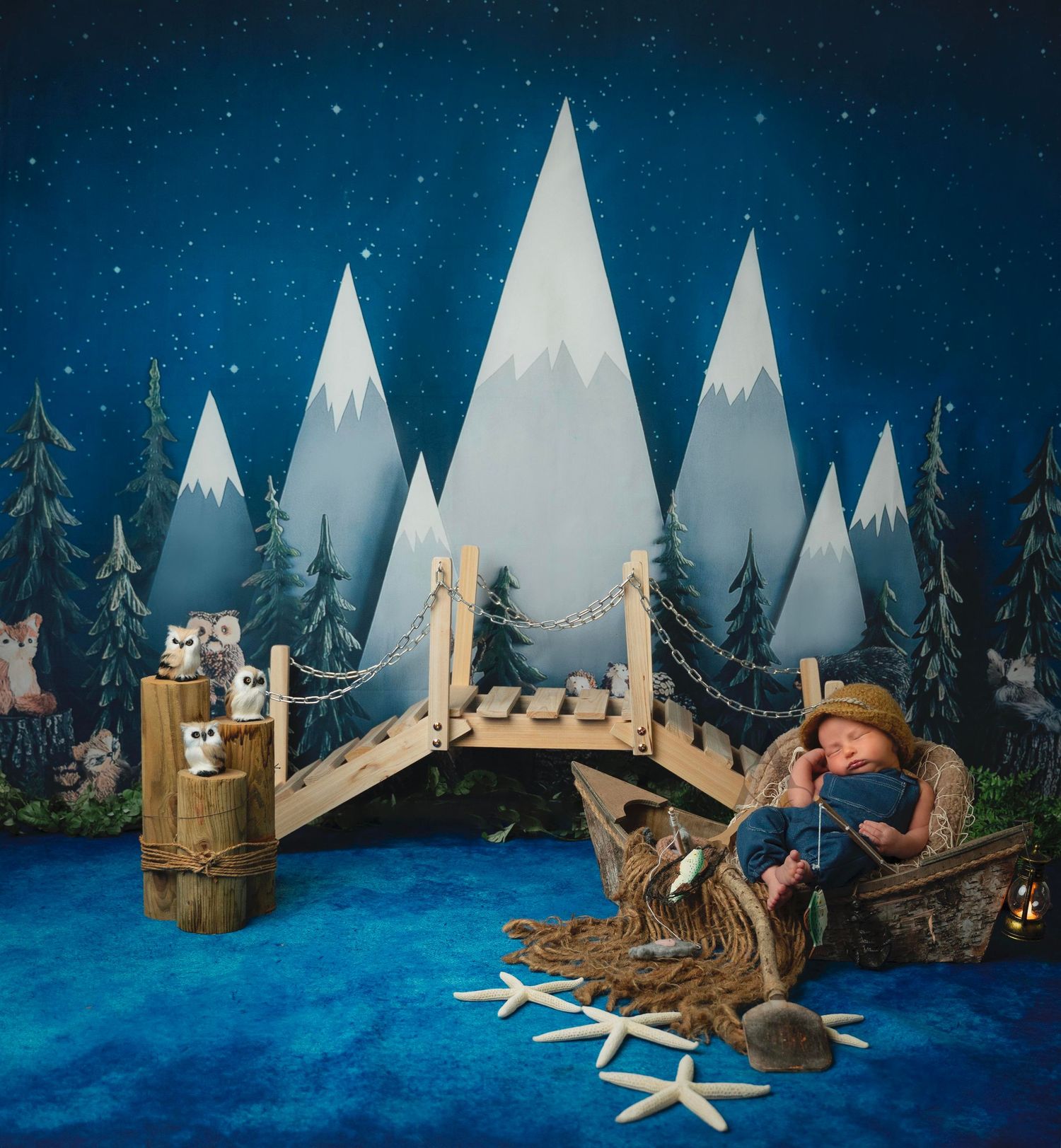 Winter wonderland scene with geometric mountains, wooden bridge, and fishing setup against starry blue sky.