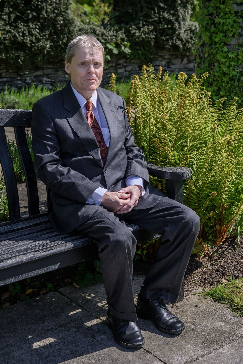 Bride's father sitting on bench in gardens at Cragwood Country House Hotel