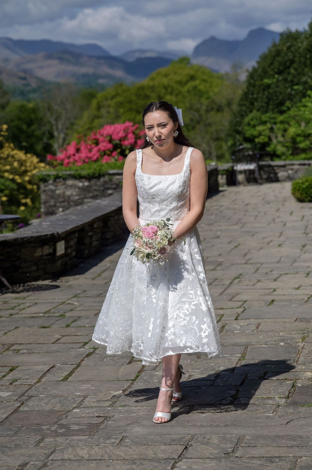 Bride walking along terrace at Cragwood Country House Hotel in the Lake District