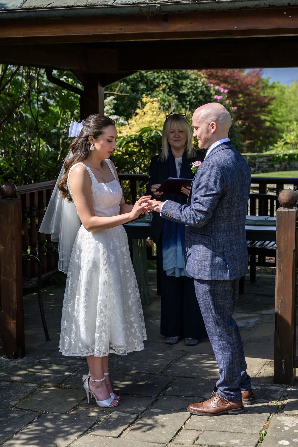 Bride putting ring on groom's finger at Cragwood Hotel wedding