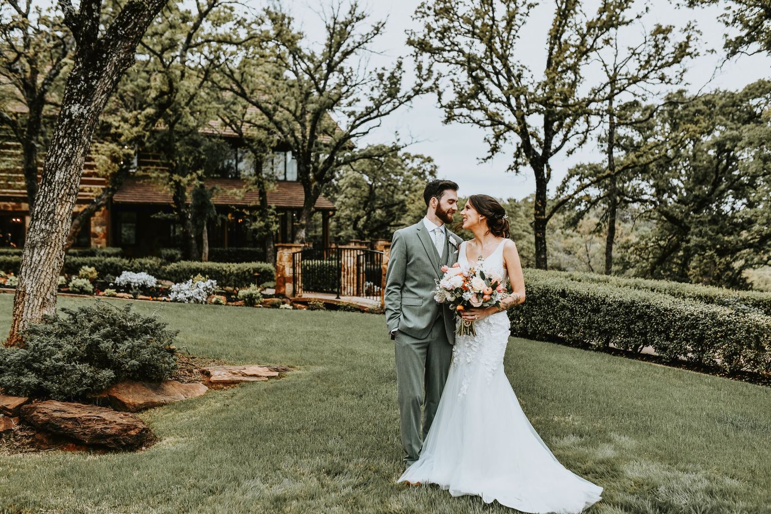 Bride and groom sharing a private vow exchange during a romantic first look in front of greenery at The Lodge at The Springs.