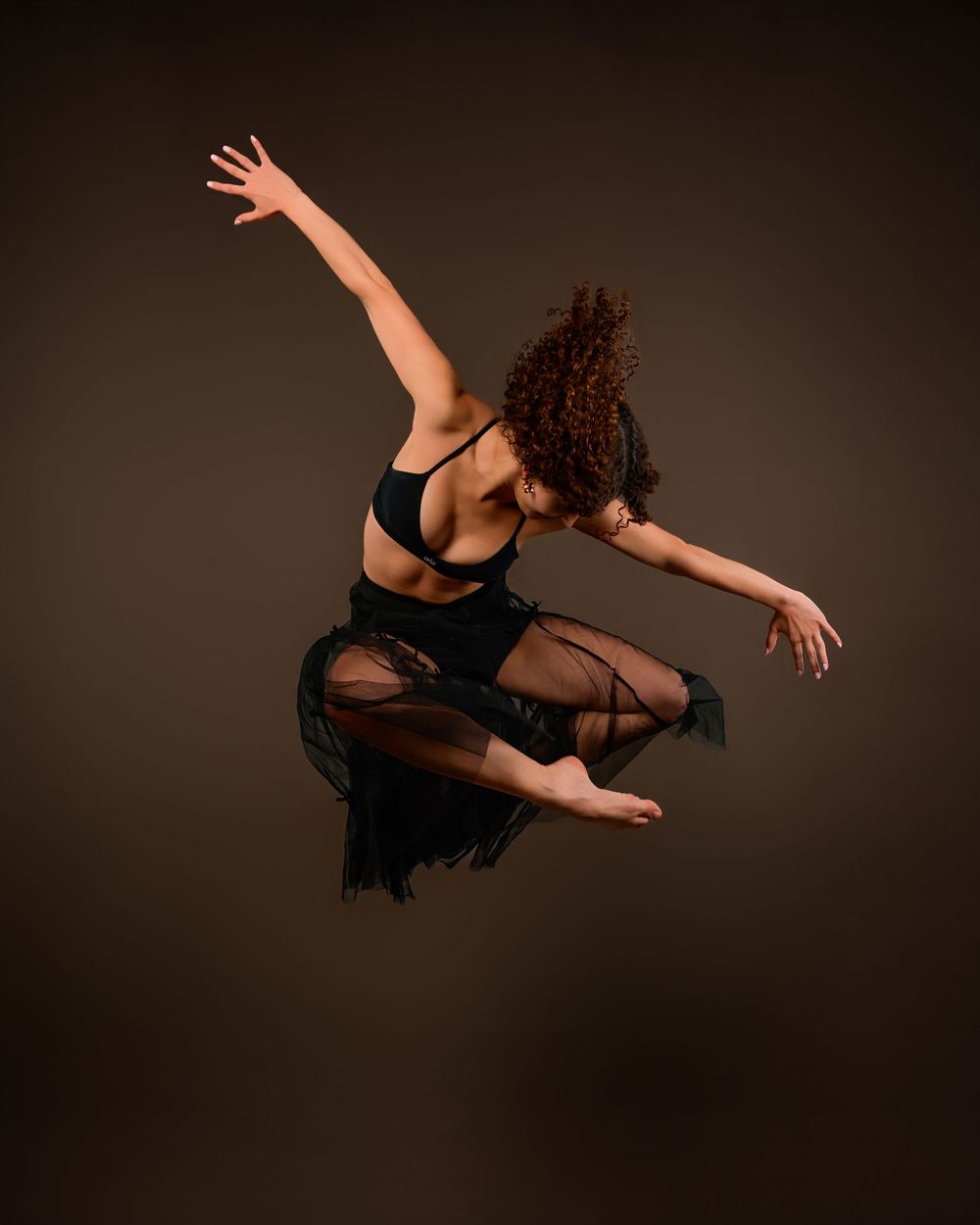 dancer Evelyn posing in a Tucson photography studio with dramatic lighting