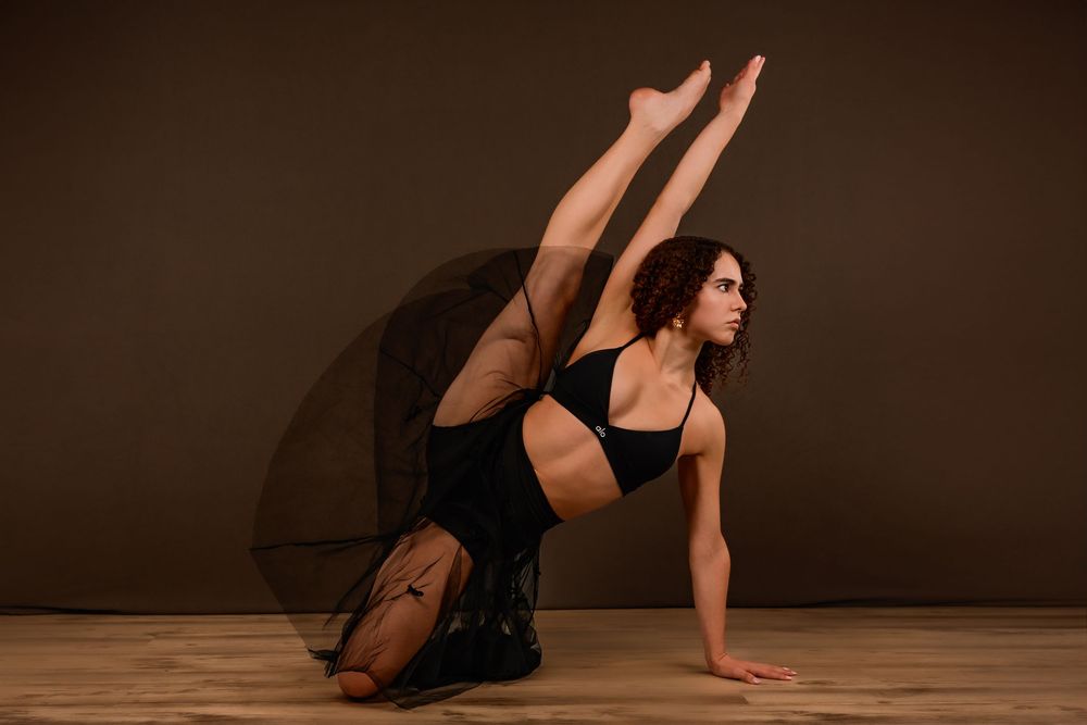 dancer Evelyn posing in a Tucson photography studio with dramatic lighting