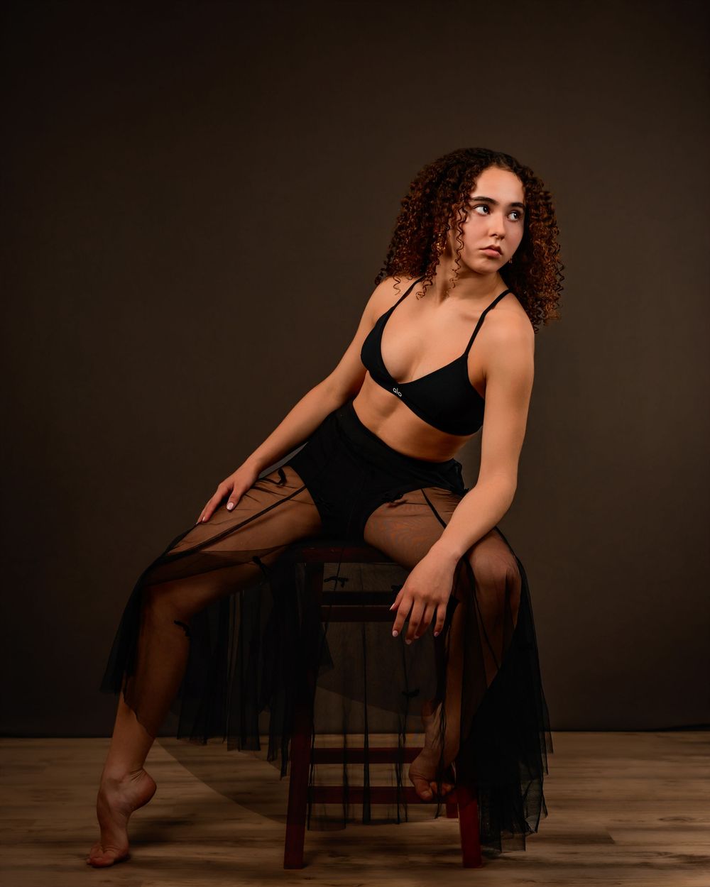 dancer Evelyn posing in a Tucson photography studio with dramatic lighting