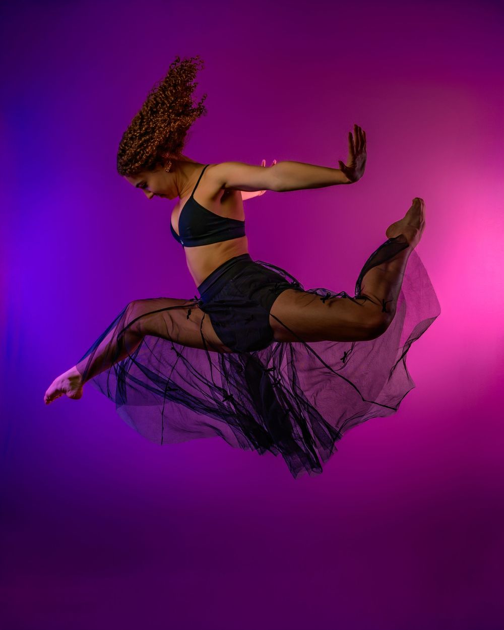 dancer Evelyn posing in a Tucson photography studio with dramatic lighting