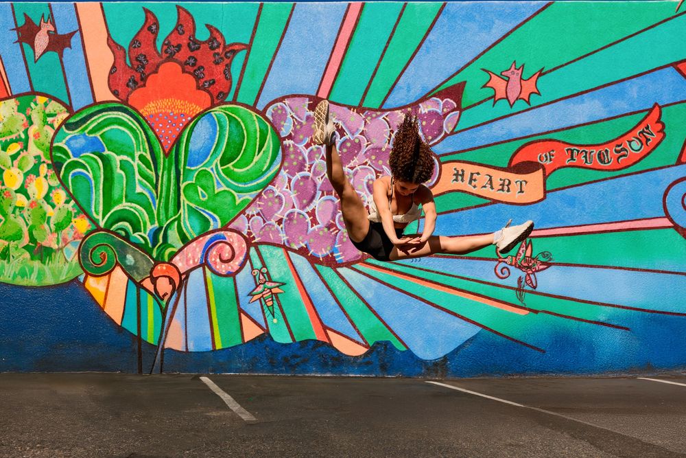 Dance portrait of Evelyn with downtown Tucson murals in the background