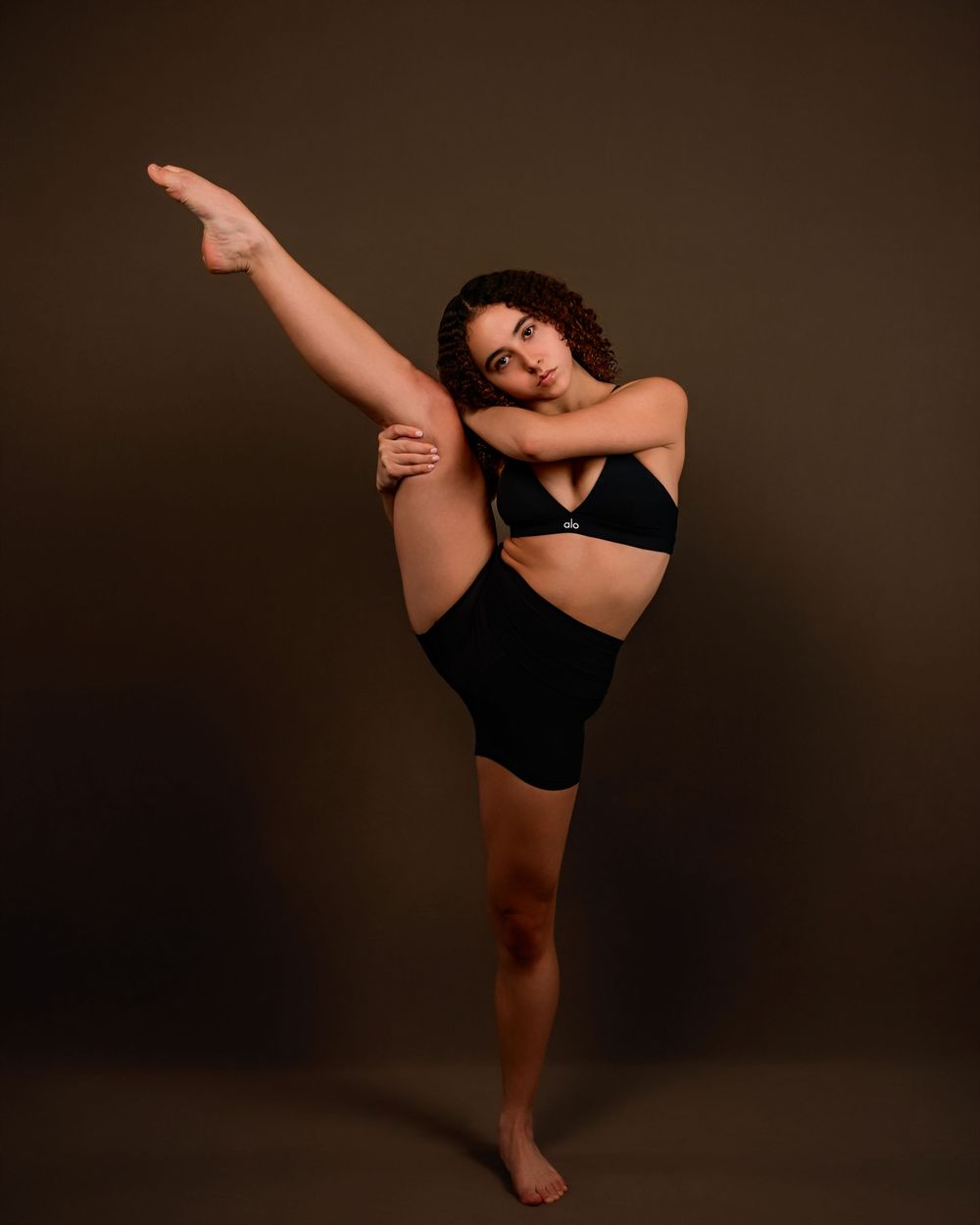 dancer Evelyn posing in a Tucson photography studio with dramatic lighting