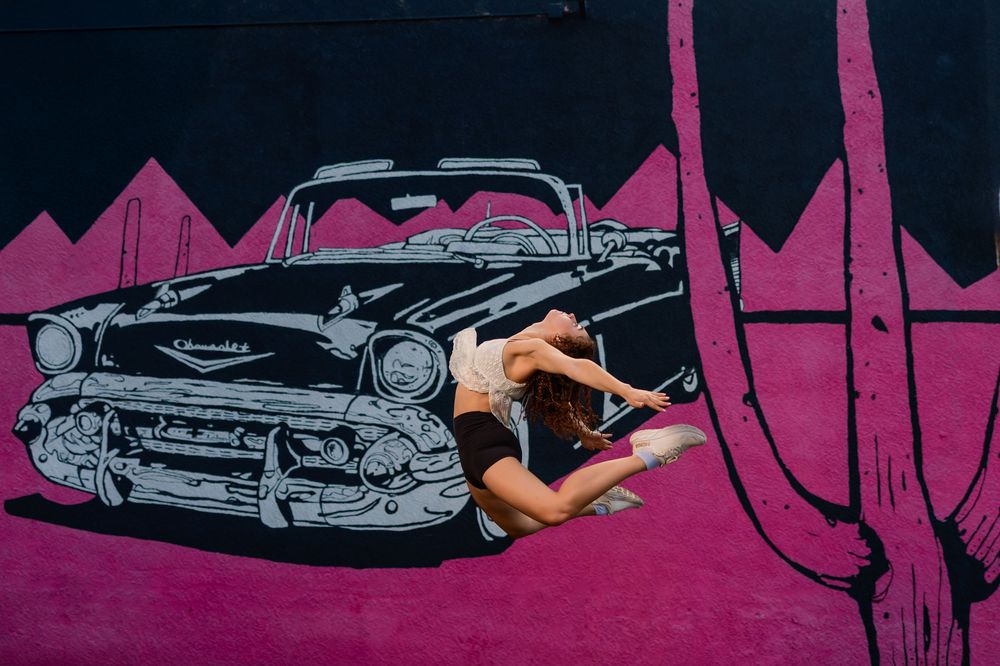 Dance portrait of Evelyn with downtown Tucson murals in the background