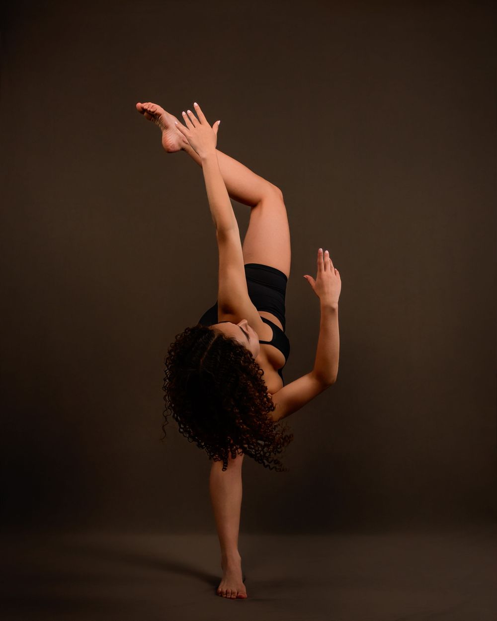 dancer Evelyn posing in a Tucson photography studio with dramatic lighting