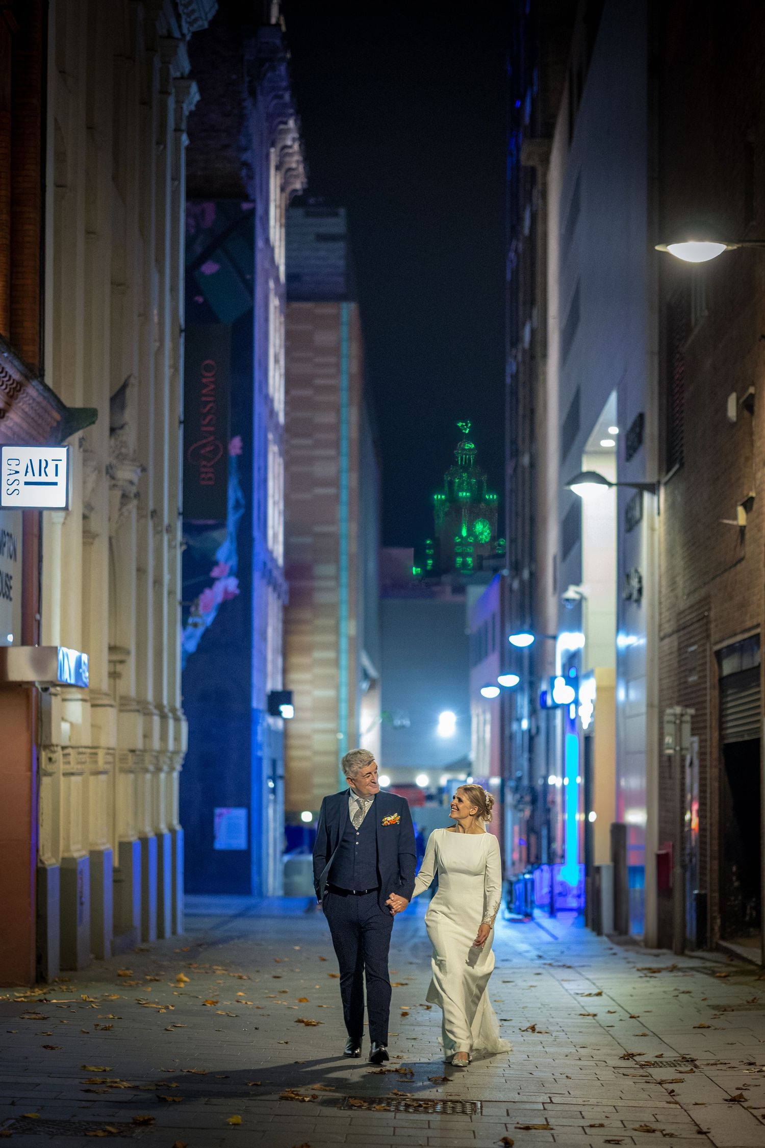 bride and groom walk towards the camera in a Liverpool City Centre street. Stuart Morris Photography Liverpool wedding photographer.