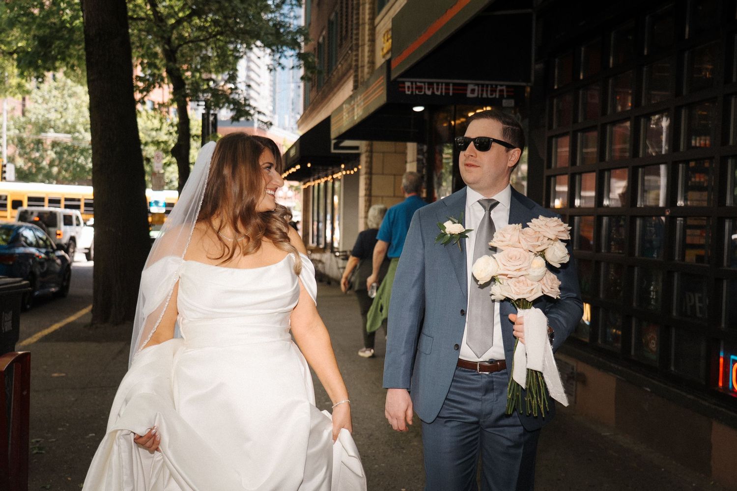 A couple enjoys dancing together at a rustic outdoor venue on their wedding day.